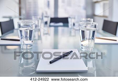 "Part of modern conference room with table chairs, notepads, pens and glasses with water" View Large Photo Image Stock Image - "Part of modern conference room with table chairs, notepads, pens and glasses with water". Fotosearch