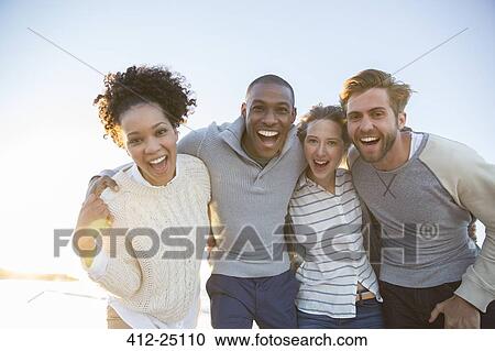 Stock Image - Portrait of cheerful friends in sunlight. Fotosearch