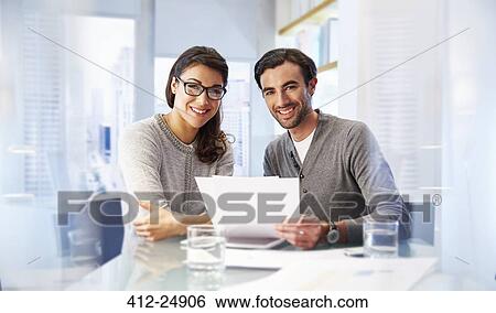 Portrait of man and woman working together in office View Large Photo Image Stock Photograph - Portrait of man and woman working together in office. Fotosearch
