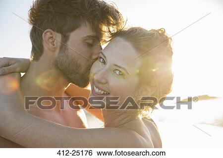 Portrait of smiling young couple in sunlight View Large Photo Image Stock Photograph - Portrait of smiling young couple in sunlight. Fotosearch