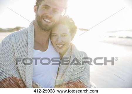 Portrait of young couple standing on beach View Large Photo Image Stock Photo - Portrait of young couple standing on beach. Fotosearch