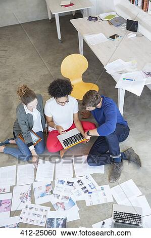 Three young people working together in studio View Large Photo Image Stock Image - Three young people working together in studio. Fotosearch