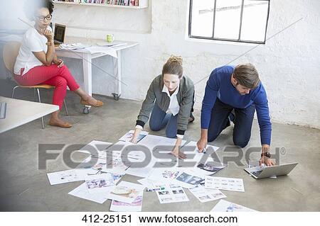 Three young people working together in studio View Large Photo Image Stock Image - Three young people working together in studio. Fotosearch