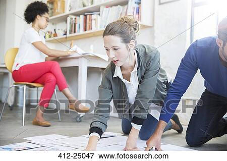 Stock Photo - Three young people working together in studio. Fotosearch