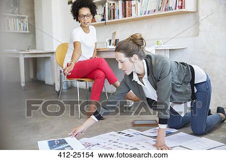 Two young women working together in studio View Large Photo Image Picture - Two young women working together in studio. Fotosearch