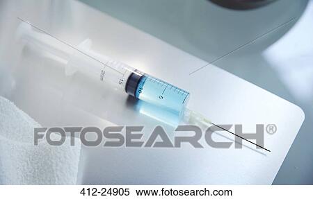 View of syringe with blue fluid on table in laboratory View Large Photo Image Stock Photography - View of syringe with blue fluid on table in laboratory. Fotosearch