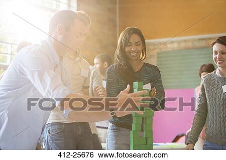 Business people stacking green blocks View Large Photo Image Stock Photograph - Business people stacking green blocks. Fotosearch