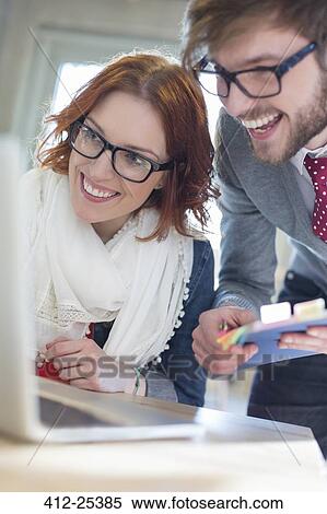 Close up of enthusiastic business people working at laptop View Large Photo Image Stock Photography - Close up of enthusiastic business people working at laptop. Fotosearch