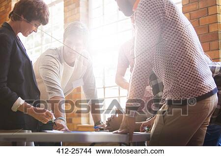 Picture - Creative business people meeting around table. Fotosearch
