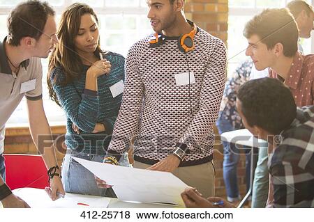 Creative business people reviewing proofs in meeting View Large Photo Image Stock Photo - Creative business people reviewing proofs in meeting. Fotosearch