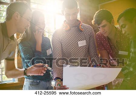 Creative business people reviewing proofs in meeting View Large Photo Image Stock Photography - Creative business people reviewing proofs in meeting. Fotosearch