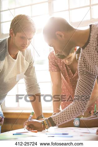 Creative business people working at table View Large Photo Image Picture - Creative business people working at table. Fotosearch