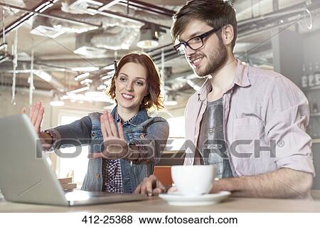 Creative business people working at laptop View Large Photo Image Stock Photo - Creative business people working at laptop. Fotosearch