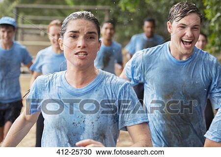 Determined woman running on boot camp obstacle course View Large Photo Image Stock Image - Determined woman running on boot camp obstacle course. Fotosearch