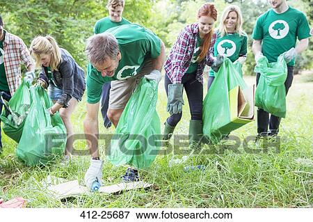 Environmentalist volunteers picking up trash View Large Photo Image Stock Photo - Environmentalist volunteers picking up trash. Fotosearch