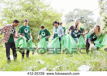 Environmentalist volunteers picking up trash View Large Photo Image Stock Photo - Environmentalist volunteers picking up trash. Fotosearch