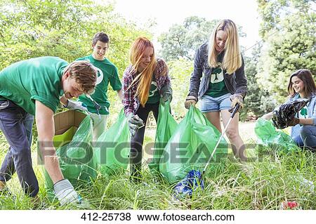 Stock Photo - Environmentalist volunteers picking up trash. Fotosearch