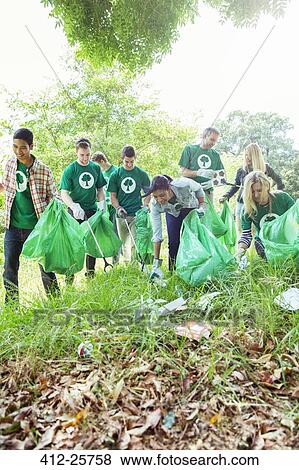 Stock Photo - Environmentalist volunteers picking up trash. Fotosearch