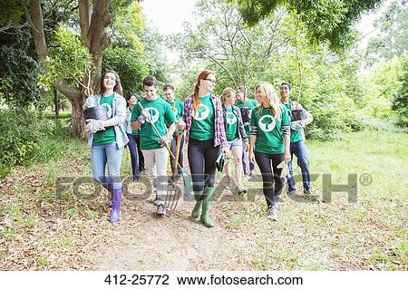 Stock Image - Environmentalist volunteers planting new tree. Fotosearch