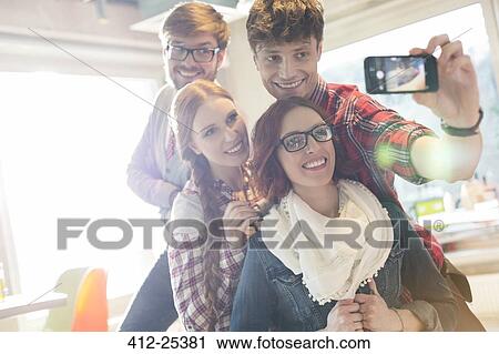 Friends taking selfie with camera phone View Large Photo Image Stock Image - Friends taking selfie with camera phone. Fotosearch
