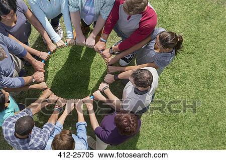 Group connected in circle around plastic hoop View Large Photo Image Stock Photography - Group connected in circle around plastic hoop. Fotosearch