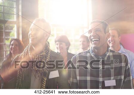 Laughing men in audience at community center View Large Photo Image Stock Image - Laughing men in audience at community center. Fotosearch
