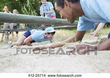 Men crawling under net on boot camp obstacle course View Large Photo Image Picture - Men crawling under net on boot camp obstacle course. Fotosearch