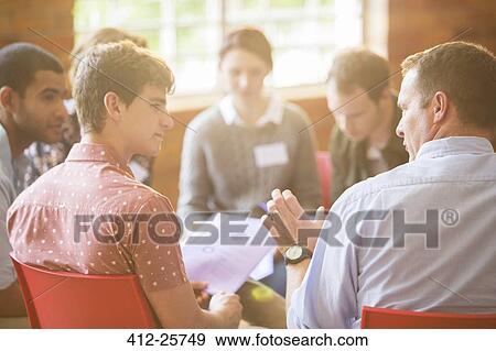 Men talking in group therapy session View Large Photo Image Stock Photo - Men talking in group therapy session. Fotosearch
