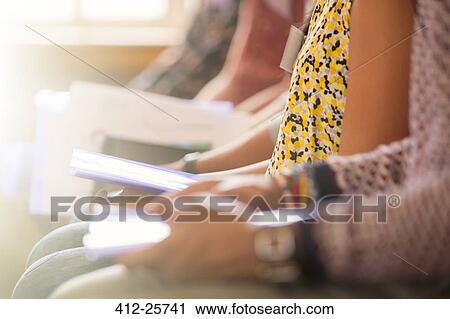 Midsection view of audience sitting in a row with paperwork View Large Photo Image Stock Image - Midsection view of audience sitting in a row with paperwork. Fotosearch