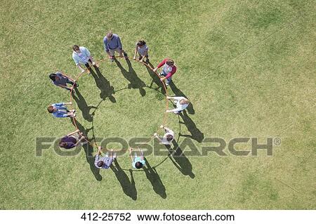 Overhead view of team connected in circle around plastic hoop View Large Photo Image Stock Image - Overhead view of team connected in circle around plastic hoop. Fotosearch
