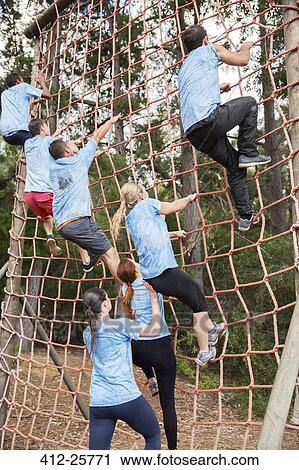People climbing net on boot camp obstacle course View Large Photo Image Stock Image - People climbing net on boot camp obstacle course. Fotosearch