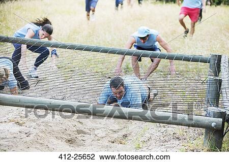 People crawling under net on boot camp obstacle course View Large Photo Image Stock Image - People crawling under net on boot camp obstacle course. Fotosearch