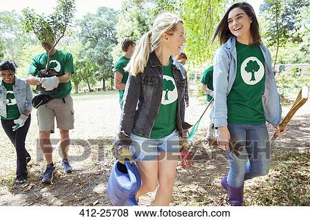 Smiling environmentalist volunteers planting new tree View Large Photo Image Stock Photo - Smiling environmentalist volunteers planting new tree. Fotosearch