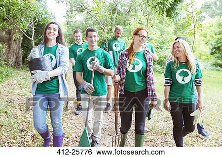 Smiling environmentalist volunteers planting new tree View Large Photo Image Stock Photograph - Smiling environmentalist volunteers planting new tree. Fotosearch