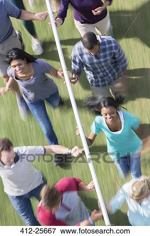 Smiling team running and balancing pole on fingertips View Large Photo Image Stock Photo - Smiling team running and balancing pole on fingertips. Fotosearch