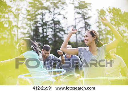 Smiling women spinning in plastic hoops View Large Photo Image Stock Image - Smiling women spinning in plastic hoops. Fotosearch
