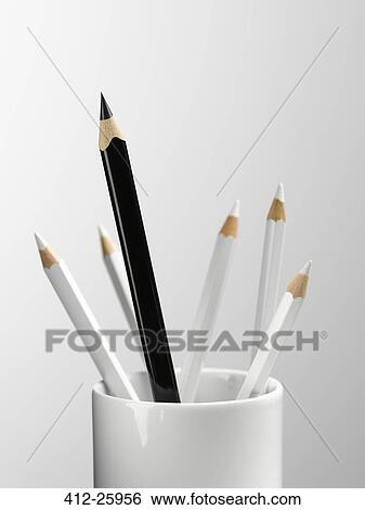 Tall black pencil in cup with smaller white pencils still life View Large Photo Image Stock Photograph - Tall black pencil in cup with smaller white pencils still life. Fotosearch