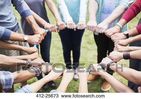 Team connected in circle around plastic hoop View Large Photo Image Stock Image - Team connected in circle around plastic hoop. Fotosearch
