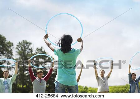 Team holding plastic hoops overhead View Large Photo Image Picture - Team holding plastic hoops overhead. Fotosearch