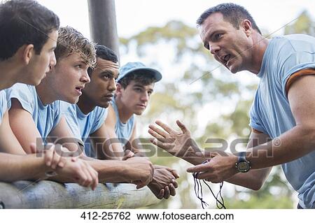Team leader motivating team at boot camp obstacle course View Large Photo Image Stock Image - Team leader motivating team at boot camp obstacle course. Fotosearch