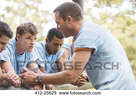 Team leader motivating tired teammates at boot camp View Large Photo Image Stock Photo - Team leader motivating tired teammates at boot camp. Fotosearch