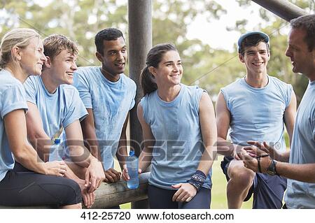 Team leader talking to teammates at boot camp View Large Photo Image Stock Image - Team leader talking to teammates at boot camp. Fotosearch