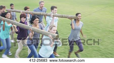Stock Image - Teams racing with logs in field. Fotosearch