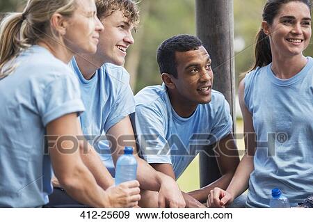Tired team resting and drinking water at boot camp View Large Photo Image Stock Photo - Tired team resting and drinking water at boot camp. Fotosearch