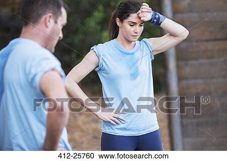 Tired woman resting on boot camp obstacle course View Large Photo Image Stock Image - Tired woman resting on boot camp obstacle course. Fotosearch