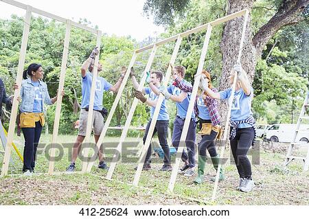 Volunteers lifting construction frame at construction site View Large Photo Image Picture - Volunteers lifting construction frame at construction site. Fotosearch
