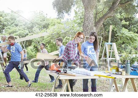 Stock Photo - Volunteers working at construction site. Fotosearch