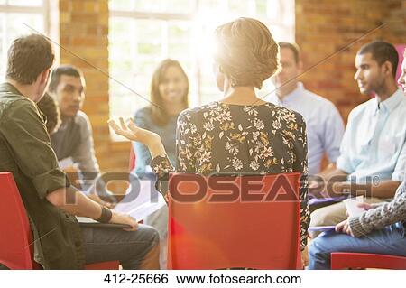 Stock Photograph - Woman speaking in group therapy session. Fotosearch