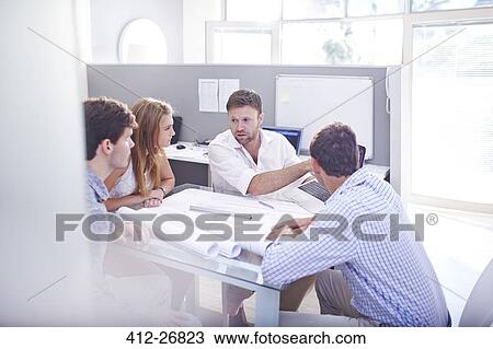 Architects discussing blueprints in meeting in office View Large Photo Image Stock Image - Architects discussing blueprints in meeting in office. Fotosearch