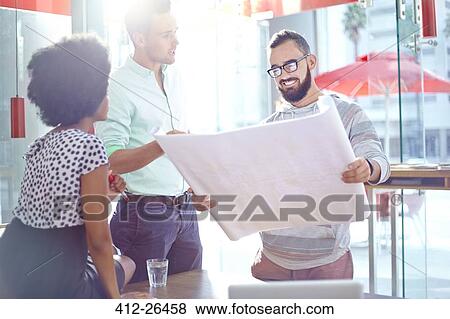 Stock Photo - Architects discussing blueprints. Fotosearch